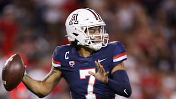 TUCSON, ARIZONA - OCTOBER 08: Quarterback Jayden de Laura #7 of the Arizona Wildcats looks to pass during the first half of the NCAAF game against the Oregon Ducks at Arizona Stadium on October 08, 2022 in Tucson, Arizona. The Ducks defeated the Wildcats 49-22. (Photo by Christian Petersen/Getty Images)