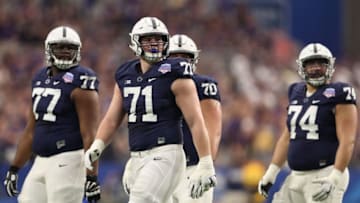 GLENDALE, AZ - DECEMBER 30: (L-R) Chasz Wright #77, Will Fries #71 and Steven Gonzalez #74 of the Penn State Nittany Lions walk the field during the Playstation Fiesta Bowl against the Washington Huskies at University of Phoenix Stadium on December 30, 2017 in Glendale, Arizona. The Nittany Lions defeated the Huskies 35-28. (Photo by Christian Petersen/Getty Images)