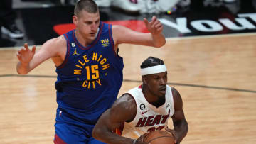 Jun 7, 2023; Miami, Florida, USA; Miami Heat forward Jimmy Butler (22) dribbles the ball against Denver Nuggets center Nikola Jokic (15) during the third quarter in game three of the 2023 NBA Finals at Kaseya Center. Mandatory Credit: Jim Rassol-USA TODAY Sports