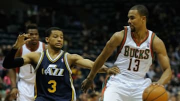 Mar 3, 2014; Milwaukee, WI, USA; Milwaukee Bucks guard Ramon Sessions (13) drives for the basket against Utah Jazz guard Trey Burke (3) in the 2nd quarter at BMO Harris Bradley Center. Mandatory Credit: Benny Sieu-USA TODAY Sports