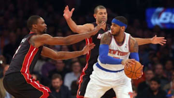 Feb 1, 2014; New York, NY, USA; New York Knicks small forward Carmelo Anthony (7) is defended by Miami Heat center Chris Bosh (1) and small forward Shane Battier (31) during the first period of a game at Madison Square Garden. Mandatory Credit: Brad Penner-USA TODAY Sports