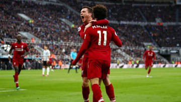 NEWCASTLE UPON TYNE, ENGLAND - MAY 04: Mohamed Salah of Liverpool celebrates with teammate Andy Robertson after scoring his team's second goal during the Premier League match between Newcastle United and Liverpool FC at St. James Park on May 04, 2019 in Newcastle upon Tyne, United Kingdom. (Photo by Clive Brunskill/Getty Images)