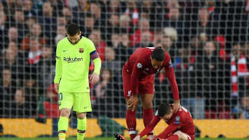 LIVERPOOL, ENGLAND - MAY 07: An injured Andy Robertson of Liverpool is checked on by team mate Virgil van Dijk during the UEFA Champions League Semi Final second leg match between Liverpool and Barcelona at Anfield on May 07, 2019 in Liverpool, England. (Photo by Shaun Botterill/Getty Images)