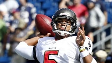 Sep 22, 2013; Foxborough, MA, USA; Tampa Bay Buccaneers quarterback Josh Freeman (5) warms up prior to a game against the New England Patriots at Gillette Stadium. Mandatory Credit: Mark L. Baer-USA TODAY Sports