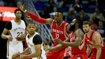 Mar 25, 2015; New Orleans, LA, USA; New Orleans Pelicans guard Eric Gordon (10) is defended by Houston Rockets center Dwight Howard (12) and guard James Harden (13) during the first quarter of a game at the Smoothie King Center. Mandatory Credit: Derick E. Hingle-USA TODAY Sports