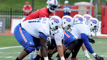 Jul 30, 2016; Pittsford, NY, USA; Buffalo Bills quarterback Tyrod Taylor (5) takes a snap with the offensive line during training camp at St. John Fisher College. Mandatory Credit: Mark Konezny-USA TODAY Sports