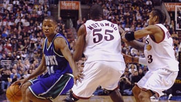 PHILADELPHIA, : The Milwaukee Bucks' guard Ray Allen (L) works his way around the Philadelphia 76ers' center Dikembe Mutombo (C) and guard Allen Iverson (R), in the 2nd quarter of their game 26 February 2001 at the First Union Center in Philadelphia. Mutombo, who was acquired in a trade last week, had a total of 10 rebounds in the first half of the game. PA AFP PHOTO/ TOM MIHALEK (Photo credit should read TOM MIHALEK/AFP/Getty Images)