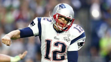Feb 1, 2015; Glendale, AZ, USA; New England Patriots quarterback Tom Brady (12) celebrates after throwing a touchdown pass against the Seattle Seahawks in the second quarter in Super Bowl XLIX at University of Phoenix Stadium. Mandatory Credit: Mark J. Rebilas-USA TODAY Sports