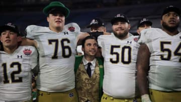 Notre Dame mascot Ryan Coury, center is squeezed between Notre Dame Fighting Irish offensive lineman Joe Alt (76), offensive lineman Rocco Spindler (50) as quarterback Tyler Buchner (12) and offensive lineman Blake Fisher (54) all sing the alma mater song after the game of the TaxSlayer Gator Bowl of an NCAA college football game Friday, Dec. 30, 2022 at TIAA Bank Field in Jacksonville. The Notre Dame Fighting Irish held off the South Carolina Gamecocks 45-38. [Corey Perrine/Florida Times-Union]
Jki 123022 Ncaaf Nd Usc Cp 9