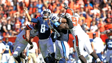 Sep 20, 2015; Cleveland, OH, USA; Tennessee Titans quarterback Marcus Mariota (8) gets the ball knocked loose while attempting a pass during the fourth quarter against the Cleveland Browns at FirstEnergy Stadium. Mandatory Credit: Andrew Weber-USA TODAY Sports