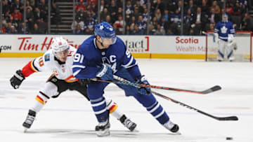 Derek Ryan #10 of the Calgary Flames skates to check John Tavares #91 of the Toronto Maple Leafs. (Photo by Claus Andersen/Getty Images)