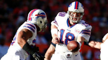 Dec 7, 2014; Denver, CO, USA; Buffalo Bills quarterback Kyle Orton (18) hands the ball off to running back Fred Jackson (22) in the first quarter against the Denver Broncos at Sports Authority Field at Mile High. Mandatory Credit: Isaiah J. Downing-USA TODAY Sports