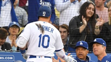 LOS ANGELES, CA - MAY 11: Justin Turner #10 is greeted at the dugout by manager Dave Roberts #30 of the Los Angeles Dodgers after hitting a two run home run in the third inning of the game against the Washington Nationals at Dodger Stadium on May 11, 2019 in Los Angeles, California. (Photo by Jayne Kamin-Oncea/Getty Images)