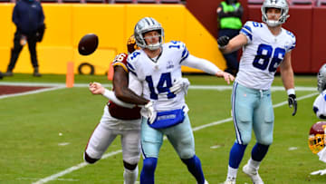 Oct 25, 2020; Landover, Maryland, USA; Washington Football Team safety Landon Collins (26) tackles Dallas Cowboys quarterback Andy Dalton (14) causing a fumble and a safety during the first quarter at FedExField. Mandatory Credit: Brad Mills-USA TODAY Sports