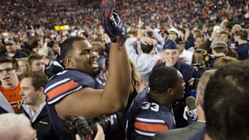 Auburn football offensive lineman Calvin Ashley (70) celebrates after the Iron Bowl NCAA football game between Auburn and Alabama on Saturday, Nov. 25, 2017, in Auburn, Ala. Auburn defeated Alabama 26-14.Auburn Alabama Football