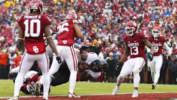 Dec 3, 2016; Norman, OK, USA; Oklahoma State Cowboys running back Chris Carson (32) scores a touchdown during the first half in front of Oklahoma Sooners linebacker Jordan Evans (26) at Gaylord Family - Oklahoma Memorial Stadium. Mandatory Credit: Kevin Jairaj-USA TODAY Sports