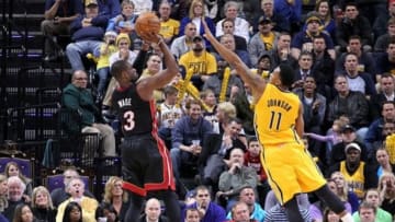 Dec 10, 2013; Indianapolis, IN, USA; Miami Heat guard Dwayne Wade (3) takes a shot against Indiana Pacers guard Orlando Johnson (11) at Bankers Life Fieldhouse. Indiana defeats Miami 90-84. Mandatory Credit: Brian Spurlock-USA TODAY Sports
