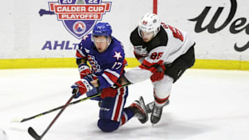 Amerks Sean Malone tries to control the puck against Utica's Kevin Bahl.
