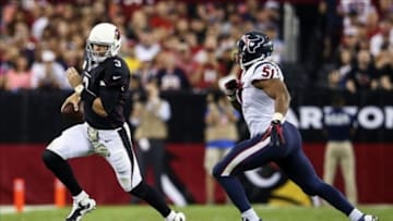 Nov 10, 2013; Phoenix, AZ, USA; Arizona Cardinals quarterback Carson Palmer (3) runs away from Houston Texans inside linebacker Darryl Sharpton (51) during the game at University of Phoenix Stadium. Arizona won 27-24. Mandatory Credit: Kevin Jairaj-USA TODAY Sports