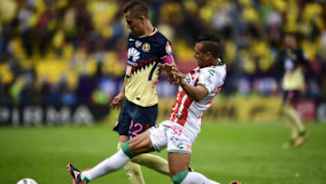 America´s Paul Aguilar (L) vies for the ball with Mario de Luna (R) of Necaxa, during their Mexican apertura 2017 tournament football match at the Azteca stadium, on October 21, 2017, in Mexico City. / AFP PHOTO / RONALDO SCHEMIDT (Photo credit should read RONALDO SCHEMIDT/AFP/Getty Images)