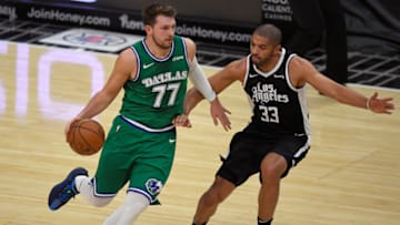 LOS ANGELES, CA - DECEMBER 27: Luka Doncic #77 of the Dallas Mavericks drives toward Nicolas Batum #33 of the LA Clippers at Staples Center on December 27, 2020 in Los Angeles, California. NOTE TO USER: User expressly acknowledges and agrees that, by downloading and/or using this photograph, user is consenting to the terms and conditions of the Getty aImages License Agreement. (Photo by John McCoy/Getty Images)