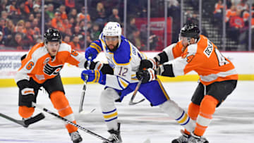 Apr 1, 2023; Philadelphia, Pennsylvania, USA; Buffalo Sabres left wing Jordan Greenway (12) battles with Philadelphia Flyers defenseman Travis Sanheim (6) and left wing Nicolas Deslauriers (44) during the first period at Wells Fargo Center. Mandatory Credit: Eric Hartline-USA TODAY Sports