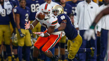 SOUTH BEND, IN - OCTOBER 29: Stacy Coley #3 of the Miami Hurricanes catches the ball as Troy Pride Jr. #18 of the Notre Dame Fighting Irish is there for the tackle at Notre Dame Stadium on October 29, 2016 in South Bend, Indiana. Notre Dame defeated Miami 30-27. (Photo by Michael Hickey/Getty Images)