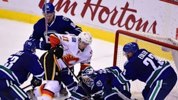 Jan 6, 2017; Vancouver, British Columbia, CAN; Vancouver Canucks goaltender Ryan Miller (30) stops the puck against Calgary Flames forward Mikael Backlund (11) during the third period at Rogers Arena. The Vancouver Canucks won 4-2. Mandatory Credit: Anne-Marie Sorvin-USA TODAY Sports