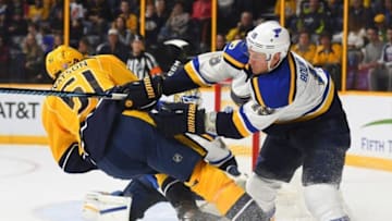 Nov 10, 2016; Nashville, TN, USA; St. Louis Blues defenseman Jay Bouwmeester (19) hits Nashville Predators left wing Austin Watson (51) as he attempts a shot during the third period at Bridgestone Arena. Mandatory Credit: Christopher Hanewinckel-USA TODAY Sports