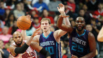 Oct 19, 2014; Chicago, IL, USA; Chicago Bulls forward Taj Gibson (22) passes the ball away from Charlotte Hornets center Cody Zeller (40) and center Al Jefferson (25) during the first half at United Center. Mandatory Credit: Jerry Lai-USA TODAY Sports
