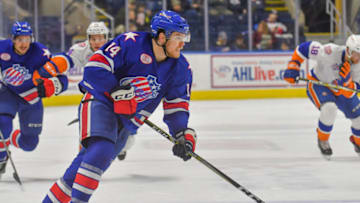 BRIDGEPORT, CT - DECEMBER 10: Sean Malone #14 of the Rochester Americans carries the puck up ice during a game against the Bridgeport Sound Tigers at the Webster Bank Arena on December 10, 2017 in Bridgeport, Connecticut. (Photo by Gregory Vasil/Getty Images)