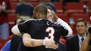 Mar 21, 2014; Miami, FL, USA; Miami Heat guard Dwyane Wade (3) hugs former teammate Memphis Grizzlies forward Mike Miller in the first half at American Airlines Arena. Mandatory Credit: Robert Mayer-USA TODAY Sports
