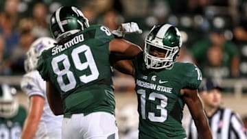 Sep 2, 2016; East Lansing, MI, USA; Michigan State Spartans defensive end Gabe Sherrod (89) celebrates with cornerback Vayante Copeland (13) after a defense stop during the second half against the Furman Paladins at Spartan Stadium. Mandatory Credit: Mike Carter-USA TODAY Sports