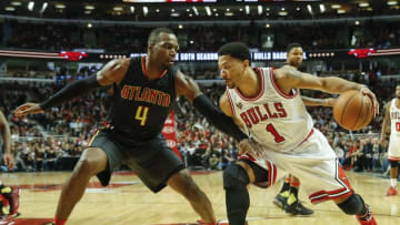 Mar 28, 2016; Chicago, IL, USA; Chicago Bulls guard Derrick Rose (1) drives to the basket against Atlanta Hawks forward Paul Millsap (4) during the second half at United Center. Mandatory Credit: Kamil Krzaczynski-USA TODAY Sports