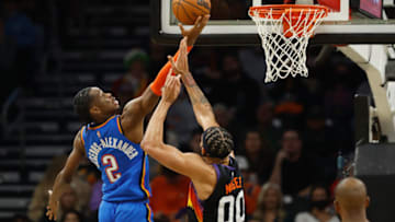 Shai Gilgeous-Alexander #2 of the Oklahoma City Thunder lays up a shot over JaVale McGee #00 of the Phoenix Suns during the second half of the NBA game at Footprint Center on December 23, 2021 in Phoenix, Arizona. The Suns defeated the Thunder 113-101. NOTE TO USER: User expressly acknowledges and agrees that, by downloading and or using this photograph, User is consenting to the terms and conditions of the Getty Images License Agreement. (Photo by Christian Petersen/Getty Images)