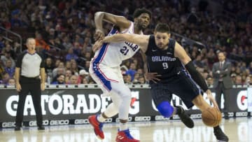 PHILADELPHIA, PA - NOVEMBER 25: Nikola Vucevic #9 of the Orlando Magic drives to the basket against Joel Embiid #21 of the Philadelphia 76ers at the Wells Fargo Center on November 25, 2017 in Philadelphia, Pennsylvania. NOTE TO USER: User expressly acknowledges and agrees that, by downloading and or using this photograph, User is consenting to the terms and conditions of the Getty Images License Agreement. (Photo by Mitchell Leff/Getty Images)