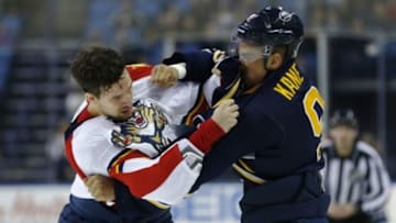 Feb 9, 2016; Buffalo, NY, USA; Florida Panthers defenseman Alex Petrovic (6) and Buffalo Sabres left wing Evander Kane (9) fight during the second period at First Niagara Center. Mandatory Credit: Kevin Hoffman-USA TODAY Sports