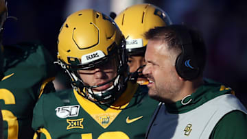 LAWRENCE, KANSAS - NOVEMBER 30: Quarterback Charlie Brewer #12 of the Baylor Bears talks with head coach Matt Rhule during the game against the Kansas Jayhawks at Memorial Stadium on November 30, 2019 in Lawrence, Kansas. (Photo by Jamie Squire/Getty Images)