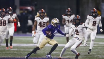 Nov 14, 2020; Seattle, Washington, USA; Washington Huskies wide receiver Terrell Bynum (4) runs for yards after the match against Oregon State Beavers defensive back Nahshon Wright (2) during the fourth quarter at Alaska Airlines Field at Husky Stadium. Mandatory Credit: Joe Nicholson-USA TODAY Sports