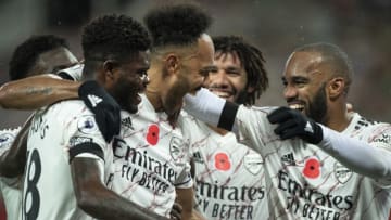 MANCHESTER, ENGLAND - NOVEMBER 01: Pierre-Emerick Aubameyang of Arsenal celebrates with team mates Alexandre Lacazette, Thomas Partey and Mohamed Elneny after scoring during the Premier League match between Manchester United and Arsenal at Old Trafford on November 1, 2020 in Manchester, United Kingdom. Sporting stadiums around the UK remain under strict restrictions due to the Coronavirus Pandemic as Government social distancing laws prohibit fans inside venues resulting in games being played behind closed doors. (Photo by Visionhaus)