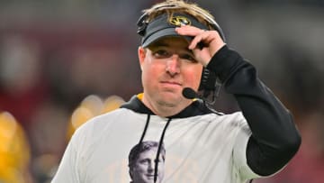TAMPA, FLORIDA - DECEMBER 23: Head coach Eliah Drinkwitz of the Missouri Tigers wears a t-shirt honoring the late Mike Leach during the Union Home Mortgage Gasparilla Bowl against the Wake Forest Demon Deacons at Raymond James Stadium on December 23, 2022 in Tampa, Florida. (Photo by Julio Aguilar/Getty Images)
