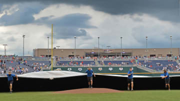 Omaha, NE - JUNE 29: The field crew runs out the tarp, with game three of the College World Series Championship Series between the Arizona Wildcats and the Coastal Carolina Chanticleers is under a weather delay on June 29, 2016 at TD Ameritrade Park in Omaha, Nebraska. (Photo by Peter Aiken/Getty Images)