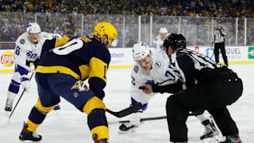 NASHVILLE, TENNESSEE - FEBRUARY 26: Colton Sissons #10 of the Nashville Predators and Ross Colton #79 of the Tampa Bay Lightning wait for the puck drop in the third period during the 2022 Navy Federal Credit Union NHL Stadium Series between the Tampa Bay Lightning and the Nashville Predators at Nissan Stadium on February 26, 2022 in Nashville, Tennessee. (Photo by Frederick Breedon/Getty Images)