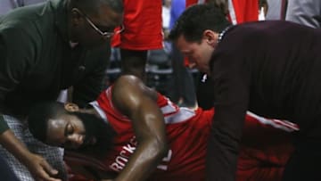 Jan 31, 2015; Auburn Hills, MI, USA; Houston Rockets guard James Harden (13) is surrounded by his teammates and trainers after he goes down with a lower body injury during the second quarter against the Detroit Pistons at The Palace of Auburn Hills. Mandatory Credit: Raj Mehta-USA TODAY Sports