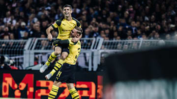 DORTMUND, GERMANY - SEPTEMBER 26: (EDITORS NOTE: Image has been digitally enhanced.) Christian Pulisic of Dortmund celebrates a goal with team mate Jacob Bruun Larsen during the Bundesliga match between Borussia Dortmund and 1. FC Nuernberg at Signal Iduna Park on September 26, 2018 in Dortmund, Germany. (Photo by Simon Hofmann/Bundesliga/DFL via Getty Images)
