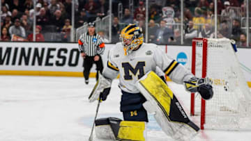 Michigan goaltender Erik Portillo looks to pass against Denver during the second period of the Frozen Four semifinal at the TD Garden in Boston on Thursday, April 7, 2022.