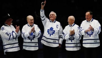 Feb 8, 2014; Toronto, Ontario, CAN; Former Toronto Maple Leafs captain George Armstong (center) waves to the crowd as he is flanked by teammates (left to right) Eddie Shack and RED KELLY and Dave Keon and Frank Mahovlich during a tribute to the 1964 Stanley Cup Champion Toronto Maple Leafs prior to the first period against the Vancouver Canucks at the Air Canada Centre. Mandatory Credit: John E. Sokolowski-USA TODAY Sports