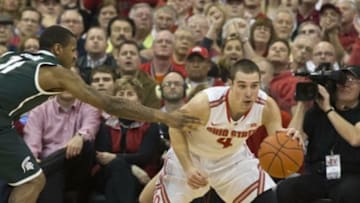 Mar 9, 2014; Columbus, OH, USA; Ohio State Buckeyes guard Aaron Craft (4) recovers the ball after stealing it from Michigan State Spartans guard Keith Appling (11) setting the Big Ten alltime record for steals at the Schottenstein Center. Ohio State won the game 69-67. Mandatory Credit: Greg Bartram-USA TODAY Sports