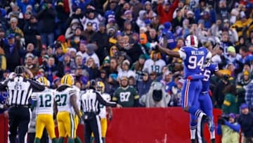 Dec 14, 2014; Orchard Park, NY, USA; Buffalo Bills defensive end Mario Williams (94) celebrates with defensive end Jerry Hughes (55) after causing a fumble against the Green Bay Packers during the second half at Ralph Wilson Stadium. The Bills beat the Packers 21-13. Mandatory Credit: Kevin Hoffman-USA TODAY Sports
