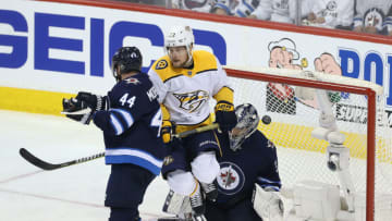 WINNIPEG, MANITOBA - MAY 1: Viktor Arvidsson #33 of the Nashville Predators and Josh Morrissey #44 and Connor Hellebuyck #37 of the Winnipeg Jets fight for space as a shot from Filip Forsberg #9 goes in for a goal in Game Three of the Western Conference Second Round during the 2018 NHL Stanley Cup Playoffs on May 1, 2018 at Bell MTS Place in Winnipeg, Manitoba, Canada. (Photo by Jason Halstead /Getty Images) *** Local Caption *** Viktor Arvidsson; Josh Morrissey; Connor Hellebuyck